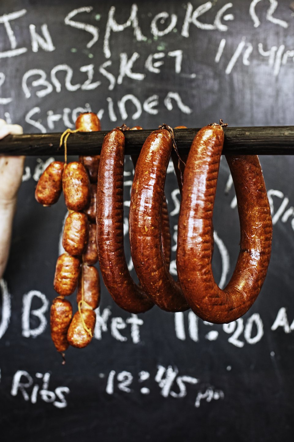 Jody Horton Photography - Smoked Sausages presented on a wood pole. 