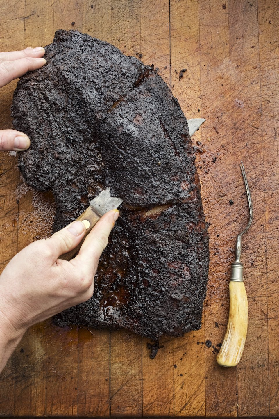 Jody Horton Photography - Barbecued brisket cut on a wood board.