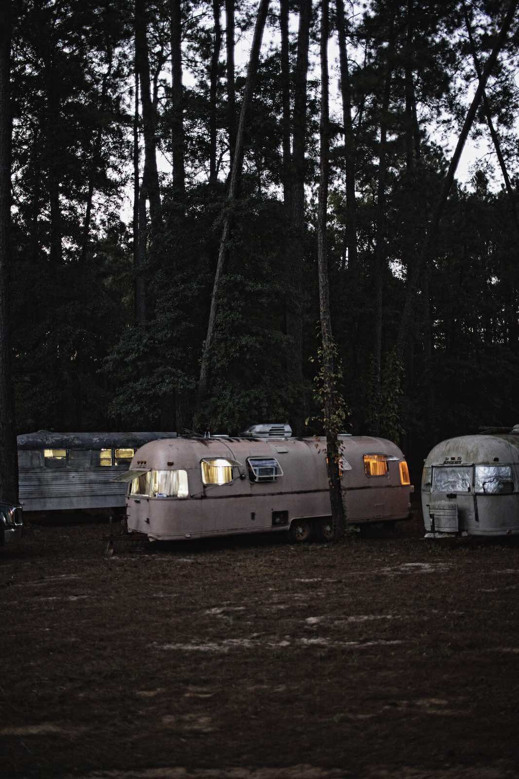 Jody Horton Photography - Vintage campers parked under trees at dusk. 