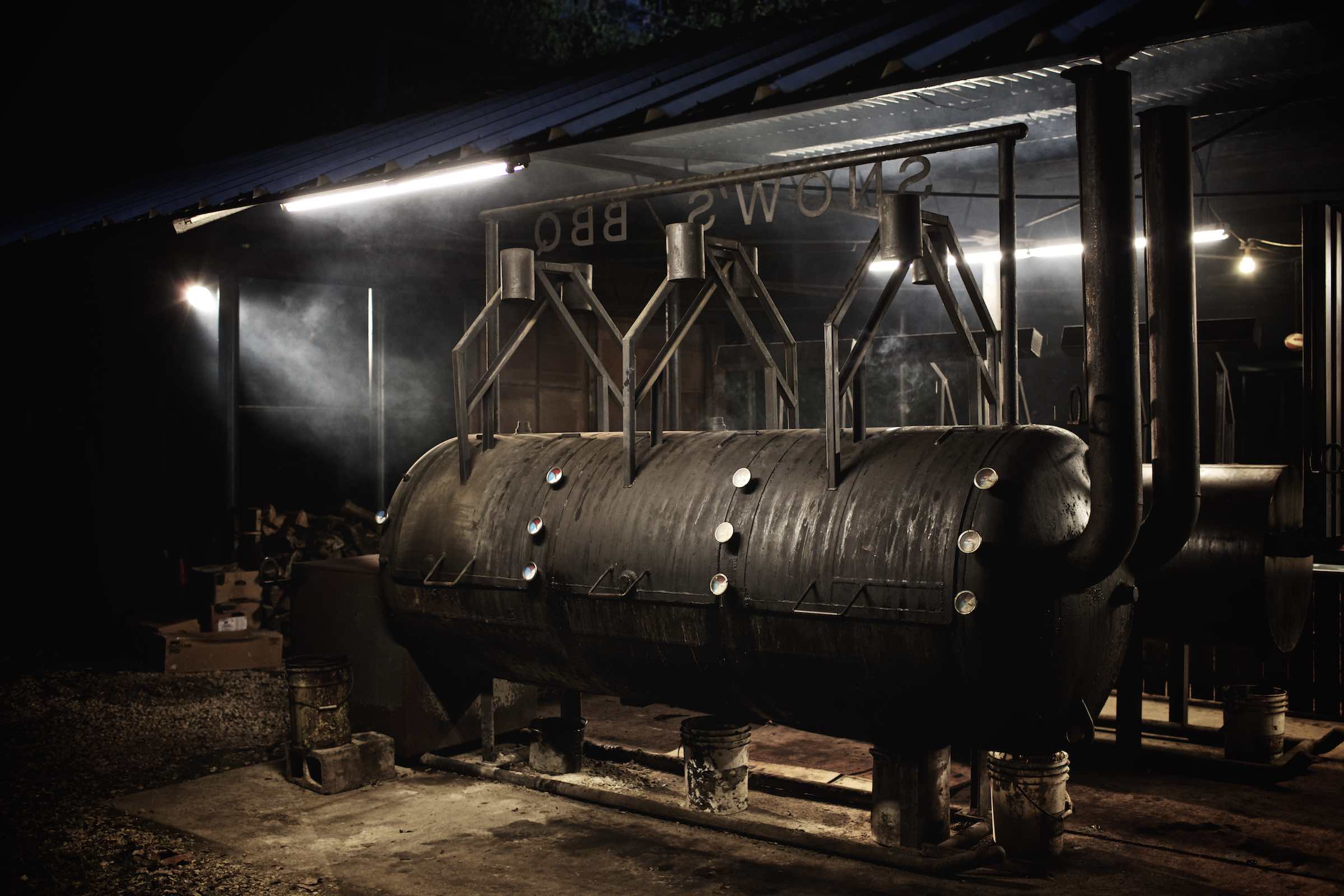 Jody Horton Photography - Large barbecue smokers underneath bright, florescnet lights. 
