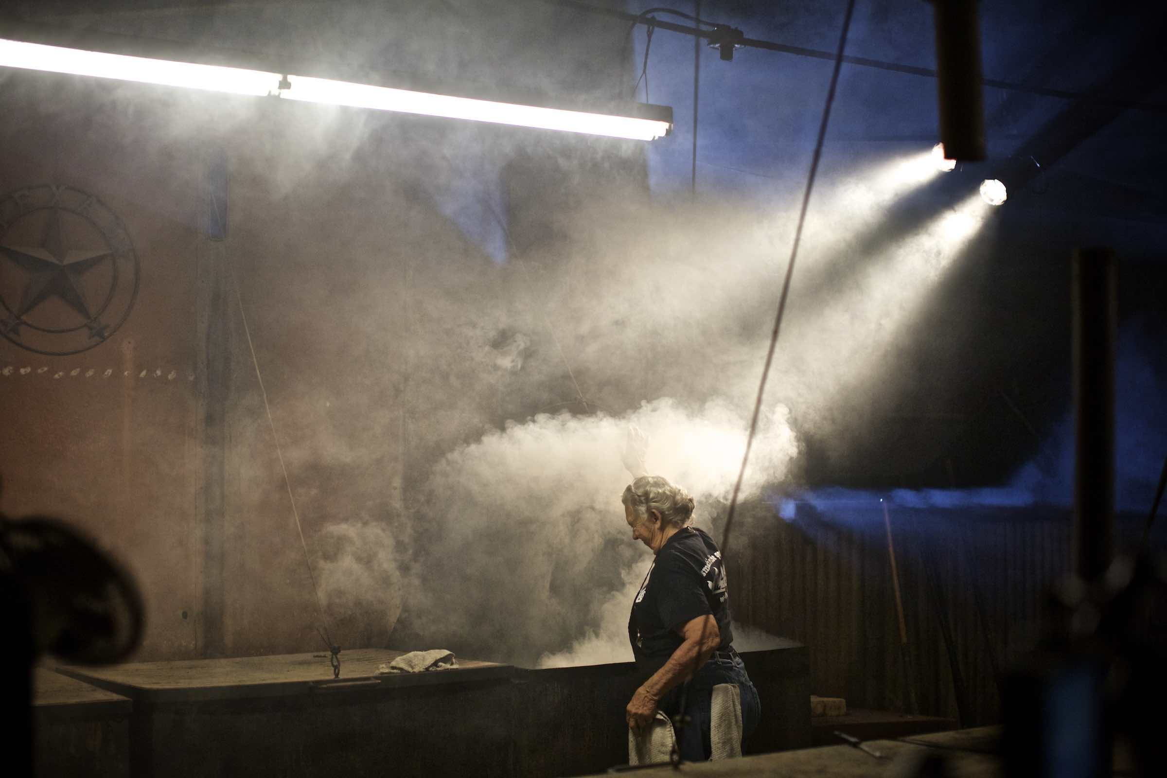 Jody Horton Photography - Pit master standing in smoke lit with bright, florescent lights. 